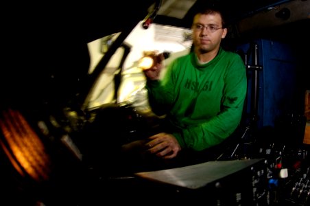 US Navy 070917-N-7883G-017 Aviation Electronics Technician 2nd Class Frank Soul, of Phillips, Wis., performs maintenance on a cooling fan in the cockpit of an SH-60B Seahawk, from the Helicopter Anti-Submarine Squadron Light 51