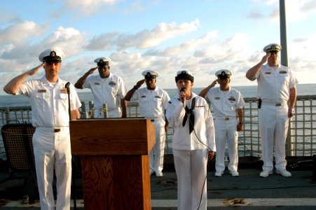 US Navy 070911-N-7029R-031 Sailors aboard dock landing ship USS Pearl Harbor (LSD 52) salute while Ship's Serviceman Seaman Samantha Ward sings the national anthem, during a memorial ceremony on the sixth anniversary of t