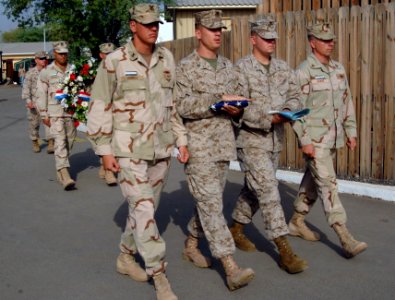 US Navy 070911-N-3285B-094 Members of the color guard march to the flagpole as chief petty officer selectees carry a wreath to be presented in remembrance of the sixth anniversary of the Sept. 11 terrorist attack photo