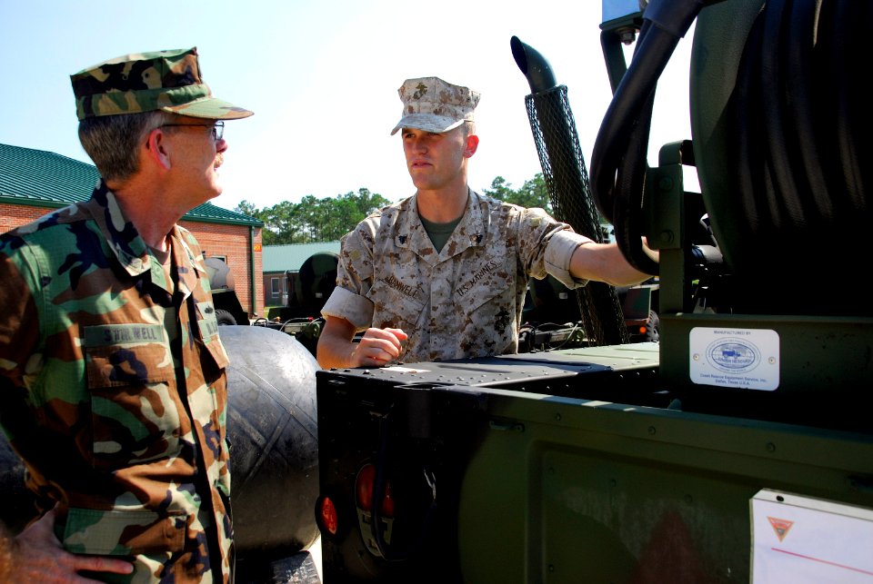 US Navy 070911-D-5854Z-005 Navy Capt. Eric L. Stillwell listens as Cpl. Brooks E. Banwell explains the capabilities of the Compressed Air Foam System Mobile (CAFSM) during a tactical ground display