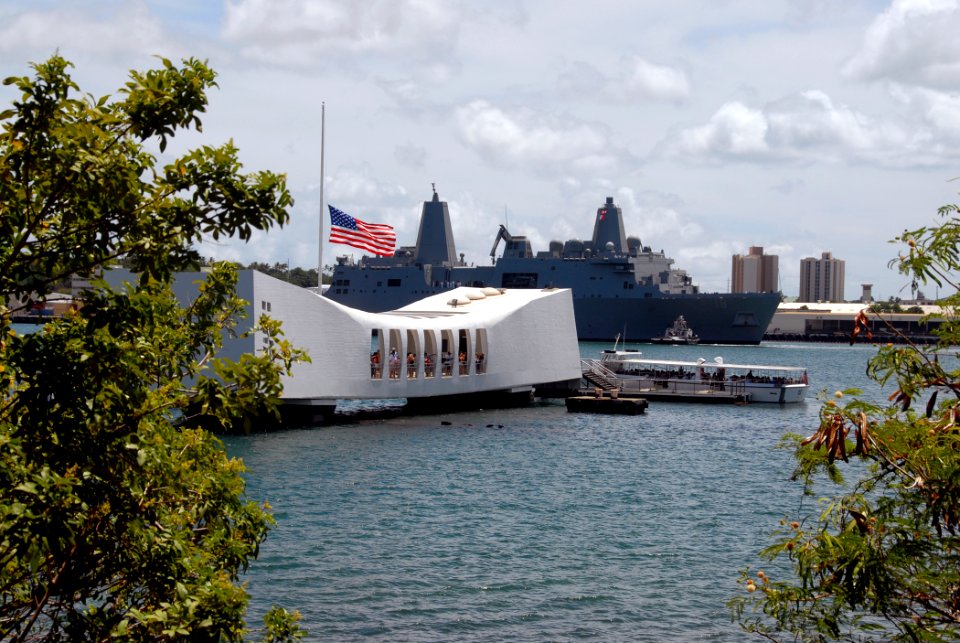 US Navy 070911-N-4965F-001 The American flag flies at half-mast aboard the USS Arizona Memorial, foreground, in memory of those who lost their lives in the Sept. 11 terrorist attacks