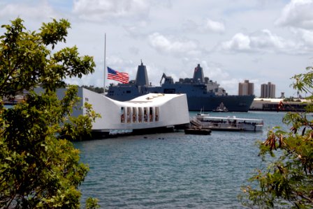 US Navy 070911-N-4965F-001 The American flag flies at half-mast aboard the USS Arizona Memorial, foreground, in memory of those who lost their lives in the Sept. 11 terrorist attacks