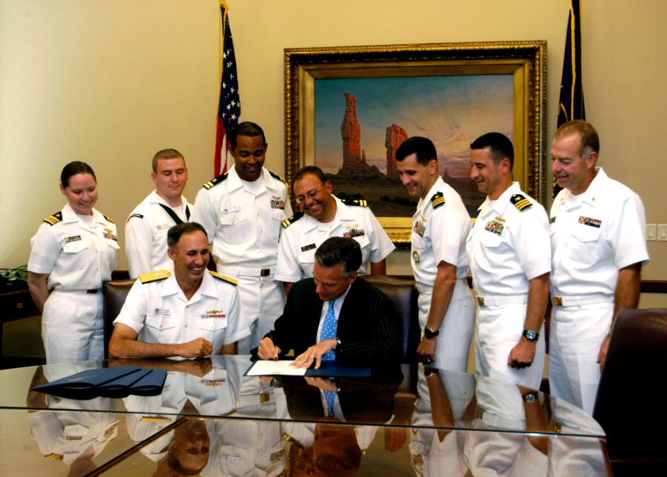 US Navy 070912-N-5208T-003 Utah Gov. Jon M. Huntsman Jr., foreground right, presents Rear Adm. Scott R. Van Buskirk, commander of Carrier Strike Group 9, an official declaration proclaiming Sept. 6-16 Utah Navy Week