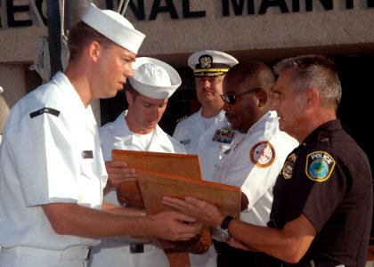 US Navy 070911-N-1522S-007 Chief petty officer selectees assigned to Southeast Regional Maintenance Center present plaques, recognizing Naval Station Mayport's police and fire departments, to Major Werner Schrenk, right, and Fi
