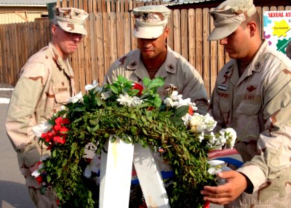 US Navy 070911-N-3285B-102 Capt. John Heckmann, commanding officer of Camp Lemonier, left, Electronics Technician 1st Class Arcenet Vazquez, and Hospital Corpsman 1st Class Eric Davenport lay a wreath in memory of the Sept. 11 photo