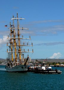 US Navy 070914-N-4965F-004 Tugboats assigned to Naval Station Pearl Harbor assist Indonesian naval training ship KRI Dewaruci as she prepares to moor at Naval Station Pearl Harbor photo