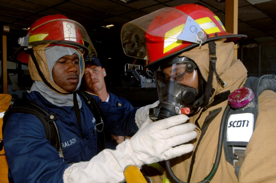 US Navy 070915-N-0989H-024 Mineman 1st Class Courtney Haralson, assigned to the High Speed Vessel (HSV 2) Swift, briefs members of the number one hose team before entering the port engine room during a fire drill