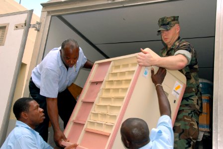 US Navy 070918-N-9486C-097 Lt. Paul Cassutti, attached to Task Group 40.9, helps workers of the Port Antonio Hospital offload Project Handclasp medical equipment
