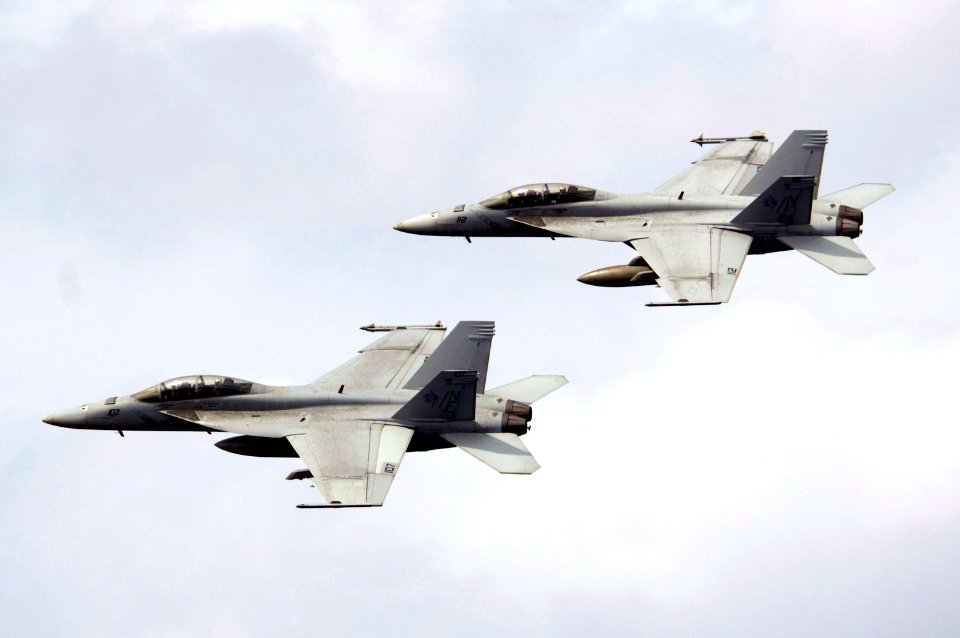 US Navy 070917-N-5387K-025 Two F-A-18E Super Hornets, assigned to the Diamondbacks of Strike Fighter Squadron (VFA) 102, perform aerial maneuvers over USS Kitty Hawk (CV 63) during a practice air show