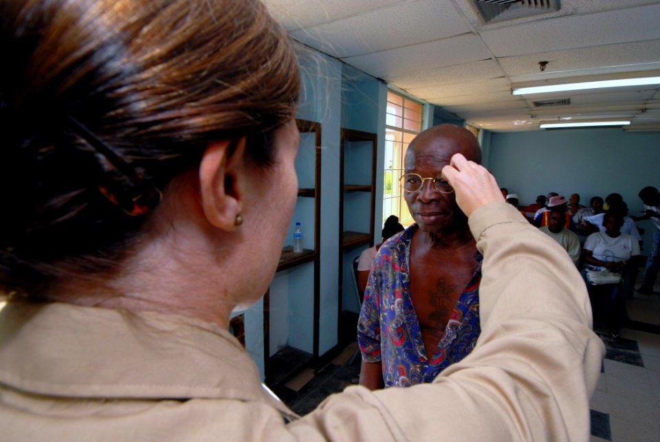 US Navy 070917-N-8704K-051 ARIMA, Trinidad and Tobago (Sept. 17, 2007) - Lt. Mary Beth Linnel, attached to Military Sealift Command hospital ship USNS Comfort (T-AH 20), fits a patient for a new pair of reading glasses at the A