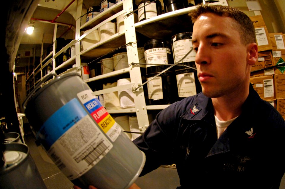 US Navy 070913-N-7883G-016 Aviation Support Equipment Technician 3rd Class Aaron Meyer inventories heat transfer fluid containers in USS Kitty Hawk's (CV 63) forward hazardous materials storeroom