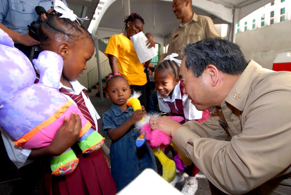 US Navy 070920-N-8704K-059 U.S. Public Health Service Rear Adm. Kenneth Moritsugu, acting U.S. surgeon general, gives stuffed animals to children