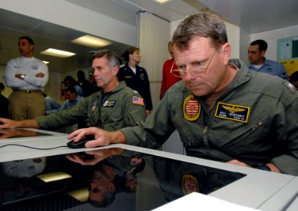 US Navy 070920-N-8923M-076 Rear Adm. William Gortney, commander of Carrier Strike Group 10, tests one of many new computers installed in a distance learning center during its grand opening aboard Nimitz-class aircraft carrier U