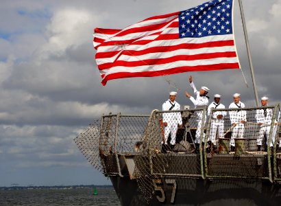 US Navy 070918-N-8907D-224 A Sailor heaves a mooring line as guided-missile destroyer USS Mitscher (DDG 57) prepares to moor pierside at Naval Station Norfolk after a six-month deployment in support of Partnership of the Americ