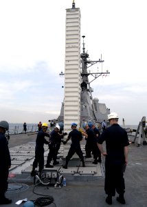 US Navy 070919-N-4649C-030 Sailors aboard guided-missile destroyer USS Lassen (DDG 82) help guide a Tomahawk cruise missile into place during ammunition onload