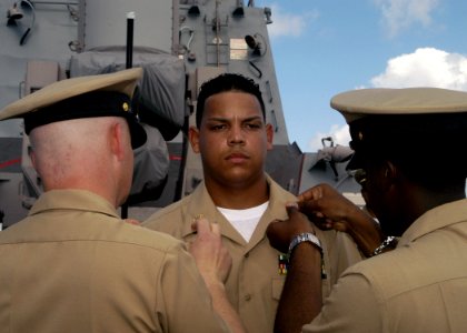 US Navy 070921-N-4649C-082 Chief Personnel Specialist Roberto Manzueta receives his chief petty officer anchors during a pinning ceremony aboard Arleigh Burke-class guided missile destroyer USS Lassen (DDG 82)