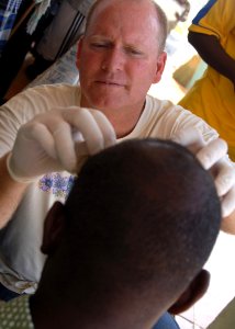 US Navy 070919-N-3285B-019 Lt. Cmdr. Randy Baldwin treats a patient's head wound during a medical civic action program (MEDCAP)