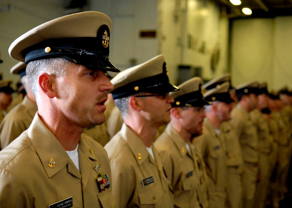 US Navy 070921-N-7981E-173 Chief Aviation Support Equipment Technician Loran Thompson and the rest of Lincoln's new chief petty officers sing
