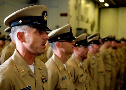 US Navy 070921-N-7981E-173 Chief Aviation Support Equipment Technician Loran Thompson and the rest of Lincoln's new chief petty officers sing