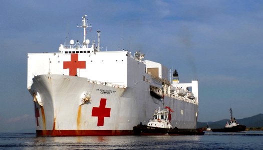 US Navy 070922-N-0194K-222 Military Sealift Command hospital ship USNS Comfort (T-AH 20) is pushed from the pier by tugboats after completing nearly a week of medical aid in Trinidad and Tobago