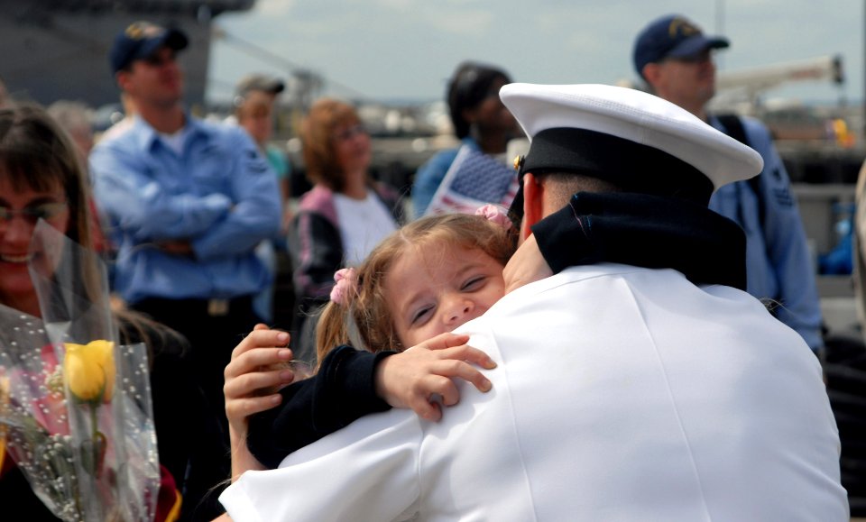 US Navy 070918-N-8907D-259 Sailors and their families reunite during the homecoming of guided-missile destroyer USS Mitscher (DDG 57) at Naval Station Norfolk after a six-month deployment in support of Partnership of the Americ