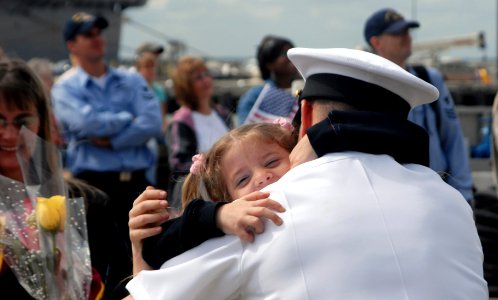US Navy 070918-N-8907D-259 Sailors and their families reunite during the homecoming of guided-missile destroyer USS Mitscher (DDG 57) at Naval Station Norfolk after a six-month deployment in support of Partnership of the Americ photo