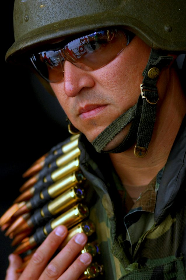 US Navy 070920-N-2984R-001 Chief Master-at-Arms Gabriel Martinez, assigned to Operations department aboard Nimitz-class aircraft carrier USS Harry S. Truman (CVN 75), waits his turn to load and fire a mounted .50-caliber machin