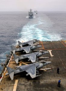 US Navy 070918-N-4774B-061 AV-8B Harriers line the flight deck of amphibious assault ship USS Tarawa (LHA 1) while dock landing ship USS Germantown (LSD 42) and other members of Tarawa battle group follow closely behind