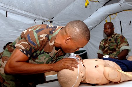 US Navy 070924-N-0989H-024 Hospital Corpsman 1st Class Charles Givens, an independent duty corpsman attached to Task Group 40.9, watches as a member of the Jamaica Defense Force perform cardiopulmonary resuscitation