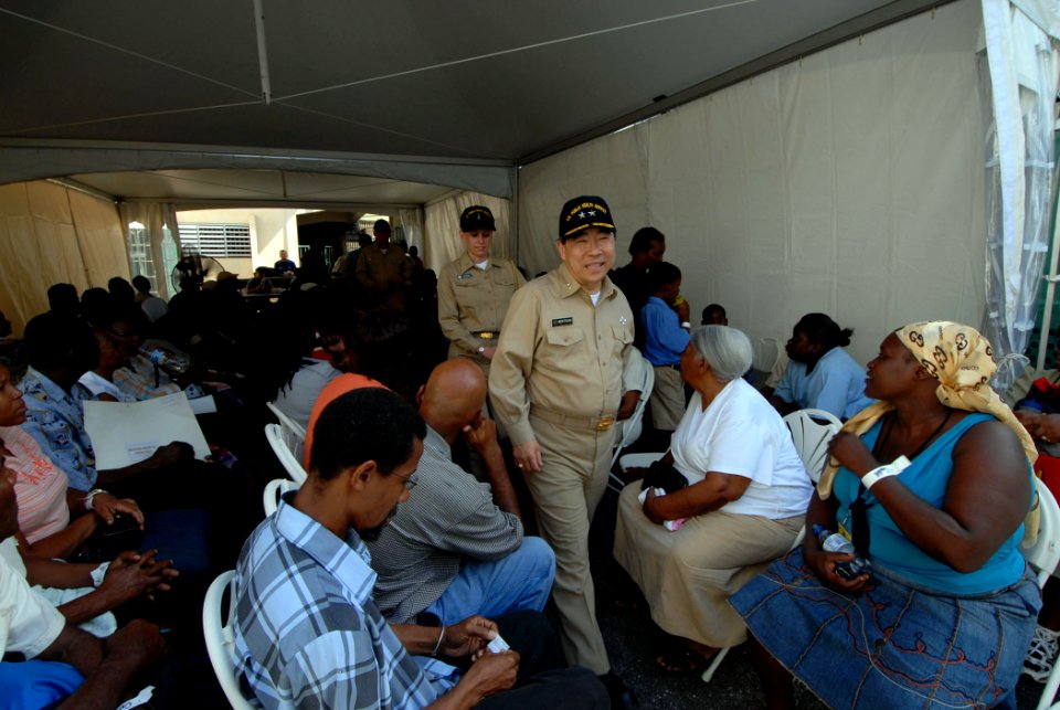 US Navy 070920-N-8704K-069 U.S. Public Health Service Rear Adm. Kenneth Moritsugu, acting U.S. surgeon general, passes through patients awaiting treatment