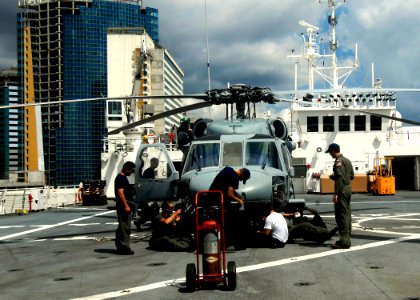 US Navy 070918-N-6278K-001 Helicopter Sea Combat Squadron (HSC) 28 members perform phased maintenance on an MH-60S Seahawk aboard Military Sealift Command hospital ship USNS Comfort (T-AH 20) photo
