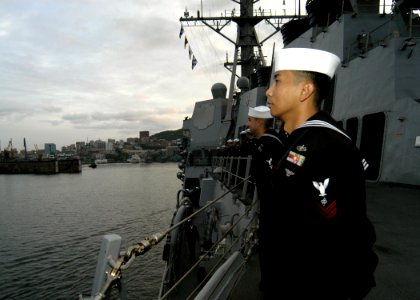 US Navy 070924-N-4649C-005 Sailors aboard Arleigh Burke-class guided-missile destroyer USS Lassen (DDG 82) man the rails as the ship makes her arrival into port
