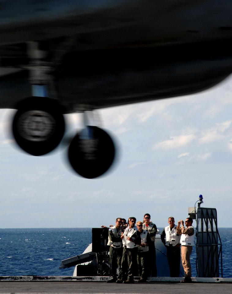 US Navy 070917-N-8923M-049 Landing signal officers (LSOs) watch from the LSO platform as an aircraft passes over the flight deck during flight operations aboard Nimitz-class aircraft carrier USS Harry S. Truman (CVN 75)
