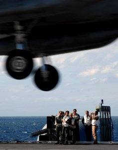 US Navy 070917-N-8923M-049 Landing signal officers (LSOs) watch from the LSO platform as an aircraft passes over the flight deck during flight operations aboard Nimitz-class aircraft carrier USS Harry S. Truman (CVN 75)