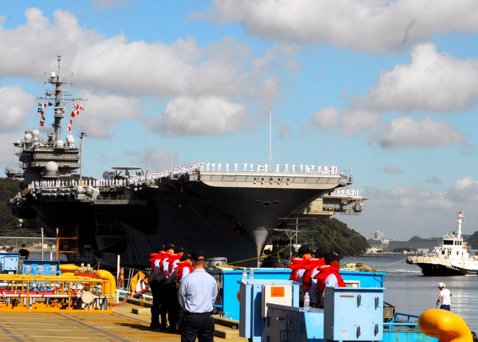 US Navy 070921-N-2638R-001 Sailors man the rails as USS Kitty Hawk (CV 63) returns to Fleet Activities Yokosuka after a four-month summer deployment