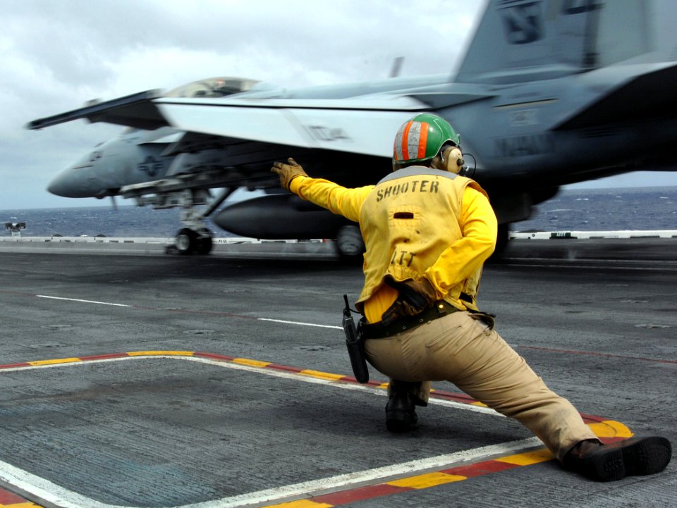 US Navy 070918-N-8923M-066 A shooter watches as an F-A-18F Super Hornet, from the