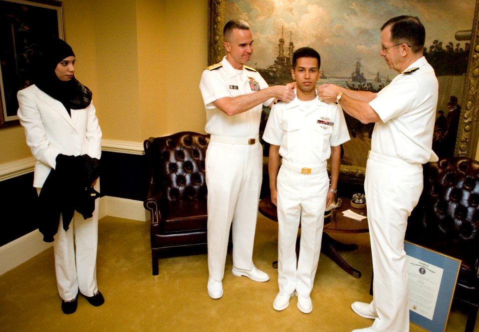 US Navy 070925-N-0696M-055 Chief of Naval Operations (CNO) Adm. Mike Mullen and Rear Adm. Alan Baker, Deputy Chief of Navy Chaplains, commission Ensign Asif Balbale in the Chaplain Corps as his wife looks on