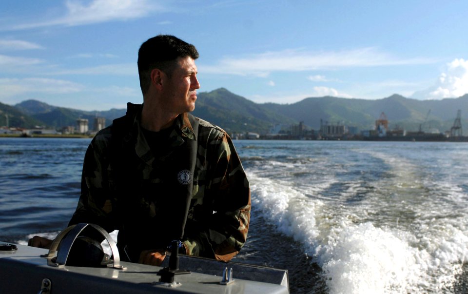 US Navy 070922-N-0194K-310 Master-at-Arms 3rd Class Pablo Ordonez, part of the security force on Military Sealift Command hospital ship USNS Comfort (T-AH 20), patrols the waters around Comfort