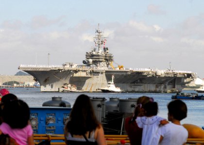 US Navy 070921-N-2638R-003 Sailors man the rails as USS Kitty Hawk (CV 63) returns to Fleet Activities Yokosuka after a four-month summer deployment