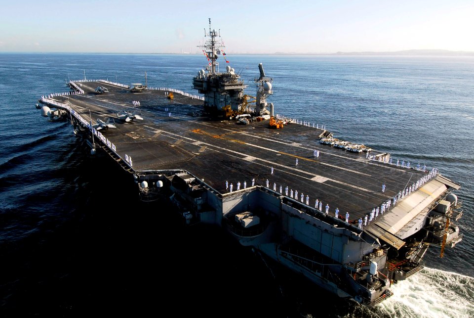 US Navy 070921-N-6106R-036 Sailors man the rails of USS Kitty Hawk (CV 63) as the ship transits into Truman Bay following a four-month summer deployment