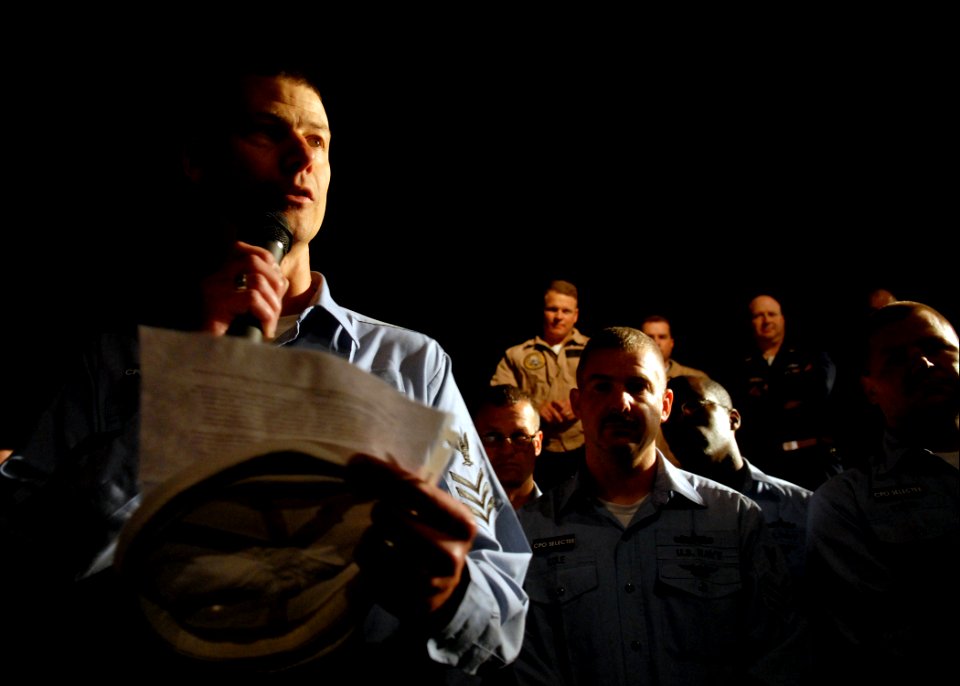 US Navy 070921-N-7981E-407 Hospital Corpsman 1st Class Trent Sickles reads the eulogy he wrote for his white hat during a white hat burial at sea, held on the fantail of Nimitz-class aircraft carrier USS Abraham Lincoln (CVN 72