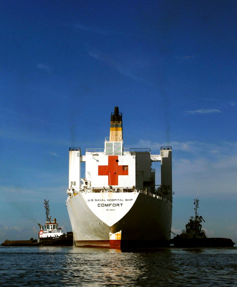 US Navy 070922-N-0194K-262 Hospital ship USNS Comfort (T-AH 20) is guided away from the pier by tugboats as she pulls out of port