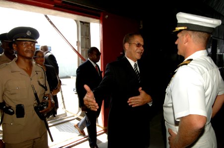 US Navy 070922-N-0989H-021 The Honorable Bruce Golding, Prime Minister to Jamaica, speaks with Capt. Douglas Wied, commander of Task Group 40.9, as he comes aboard High Speed Vessel (HSV) 2 Swift for a reception photo