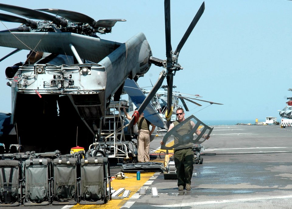 US Navy 070926-N-1226D-002 Sgt. Aaron Wise, a native of Helena, Ga., removes a panel from a CH-53E Sea Knight in preparation for an agriculture inspection aboard USS Bonhomme Richard (LHD 6)