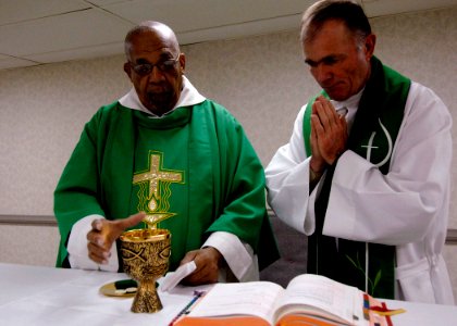 US Navy 070921-N-6278K-004 Father Joseph Harris, left, a Roman Catholic priest in Trinidad and Tobago, celebrates mass with Lt. Cmdr. Paul Evers photo