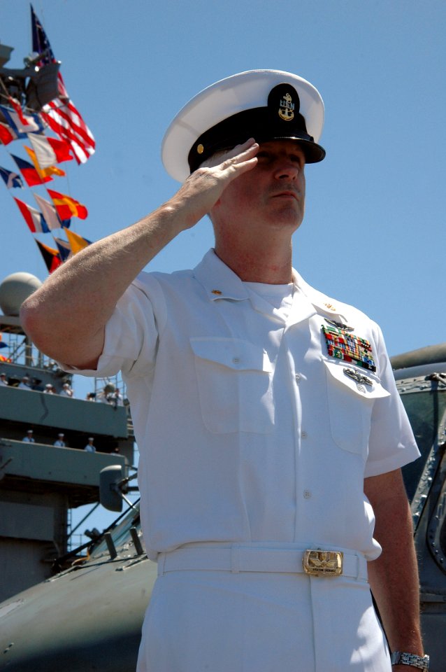 US Navy 070922-N-7128A-006 Chief Aviation Ordnanceman Samuel Johnson salutes the USS Arizona Memorial while manning the rails of nuclear-powered aircraft carrier USS Nimitz (CVN 68)
