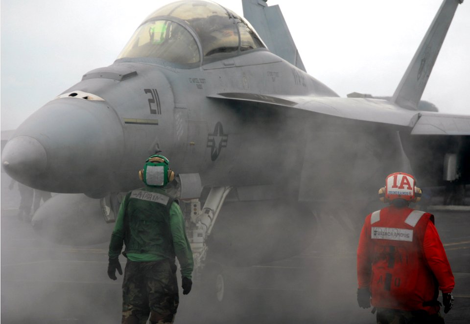 US Navy 070920-N-8923M-063 Sailors stand by as an F-A-18F Super Hornet, assigned to the Swordsmen of Strike Fighter Squadron (VFA) 32, gets into position before launching from Nimitz-class aircraft carrier USS Harry S. Truman (