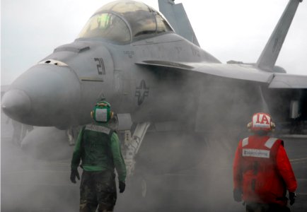 US Navy 070920-N-8923M-063 Sailors stand by as an F-A-18F Super Hornet, assigned to the Swordsmen of Strike Fighter Squadron (VFA) 32, gets into position before launching from Nimitz-class aircraft carrier USS Harry S. Truman (