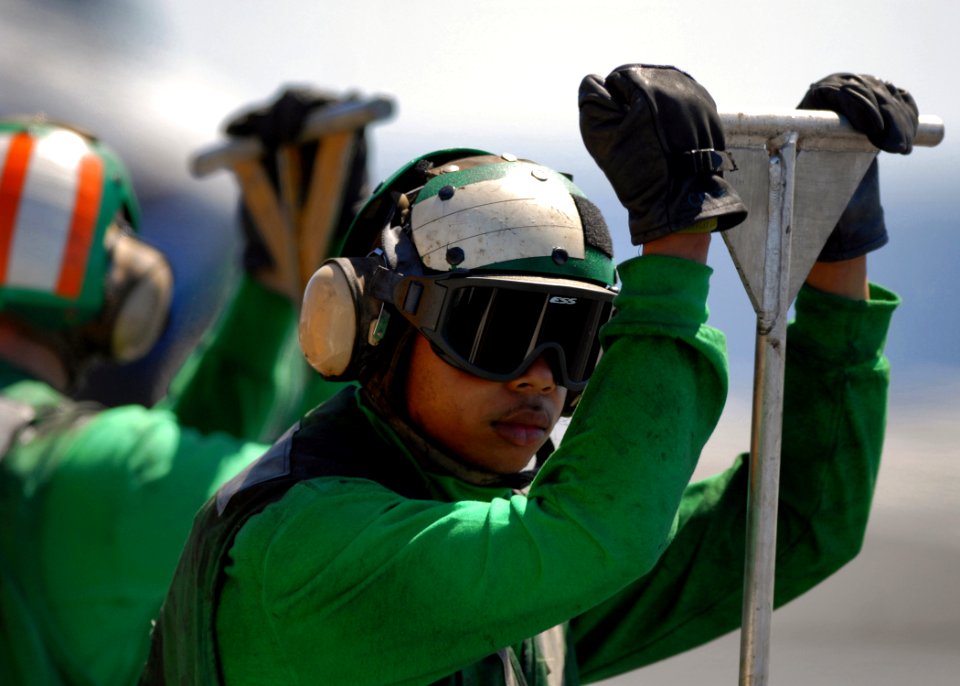 US Navy 070924-N-7981E-667 A Sailor stands ready to guide arresting gear cables back in place during flight operations aboard Nimitz-class aircraft carrier USS Abraham Lincoln (CVN 72)