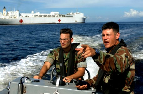 US Navy 070922-N-0194K-536 Lt.j.g. Mike Porfirio, left, and Master-at-Arms 3rd Class Pablo Ordonez conduct a security patrol in the waters around Military Sealift Command hospital ship USNS Comfort (T-AH 20) photo